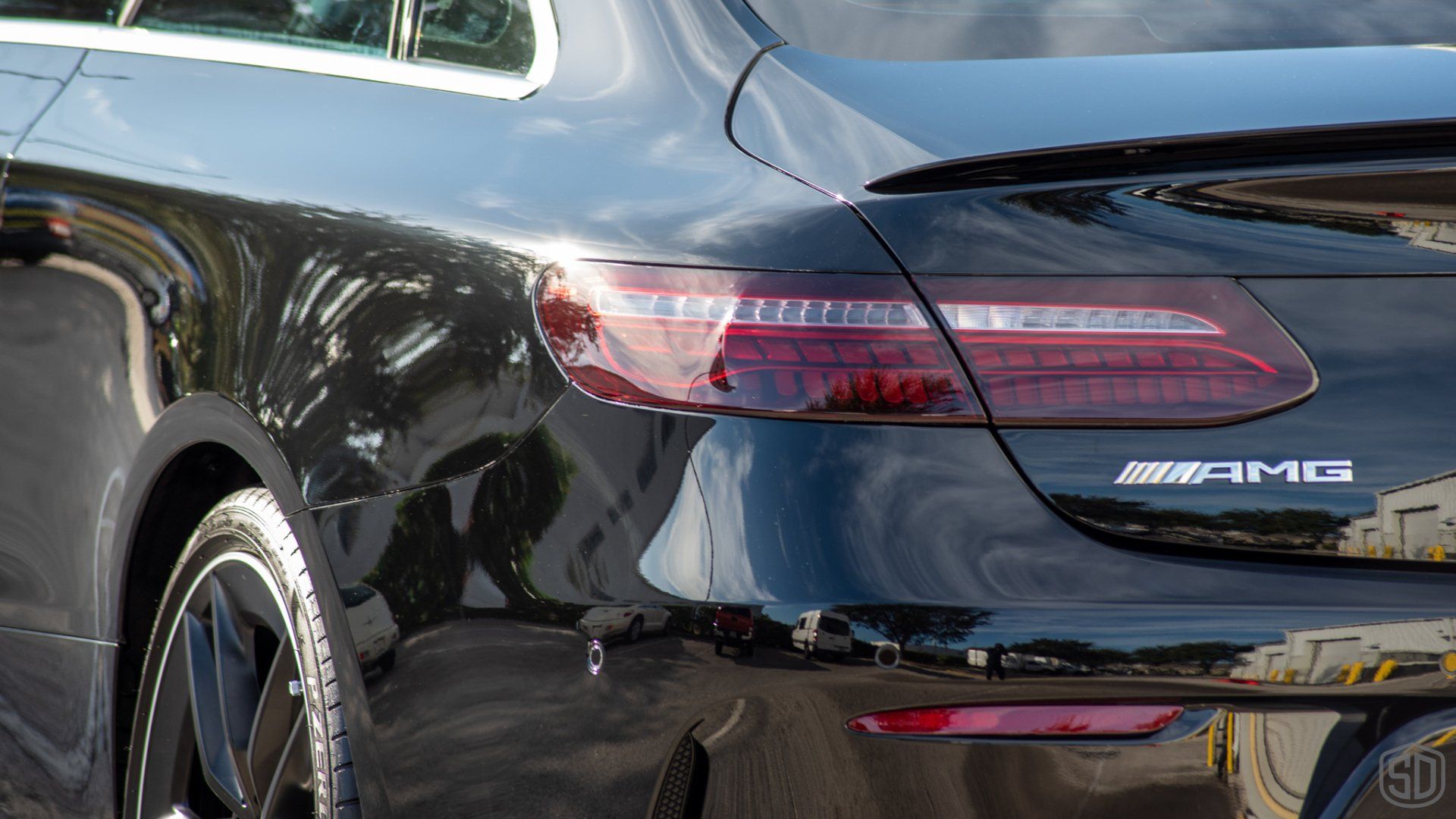 A close up of the rear end of a black mercedes amg car.