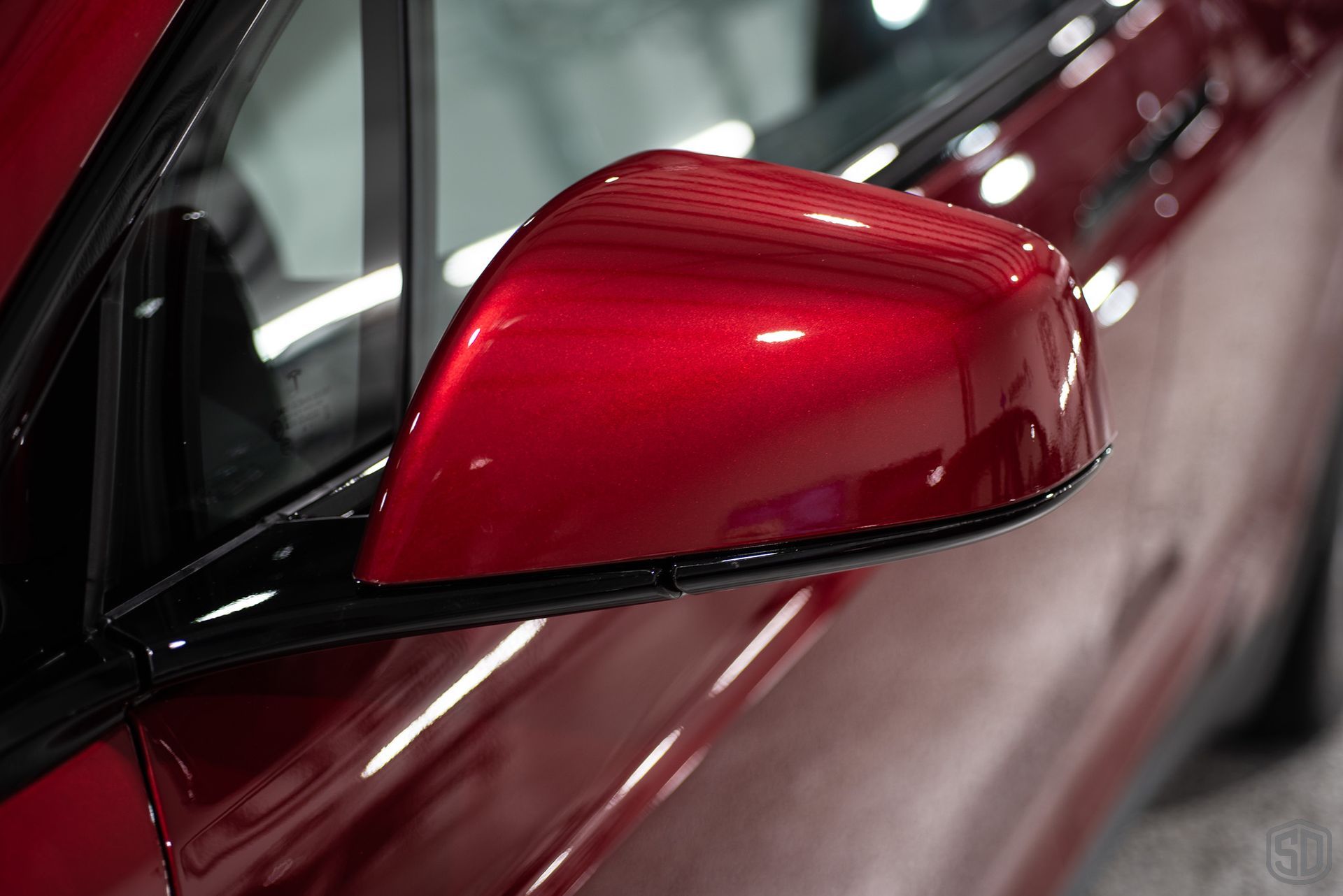 side view mirror of red tesla