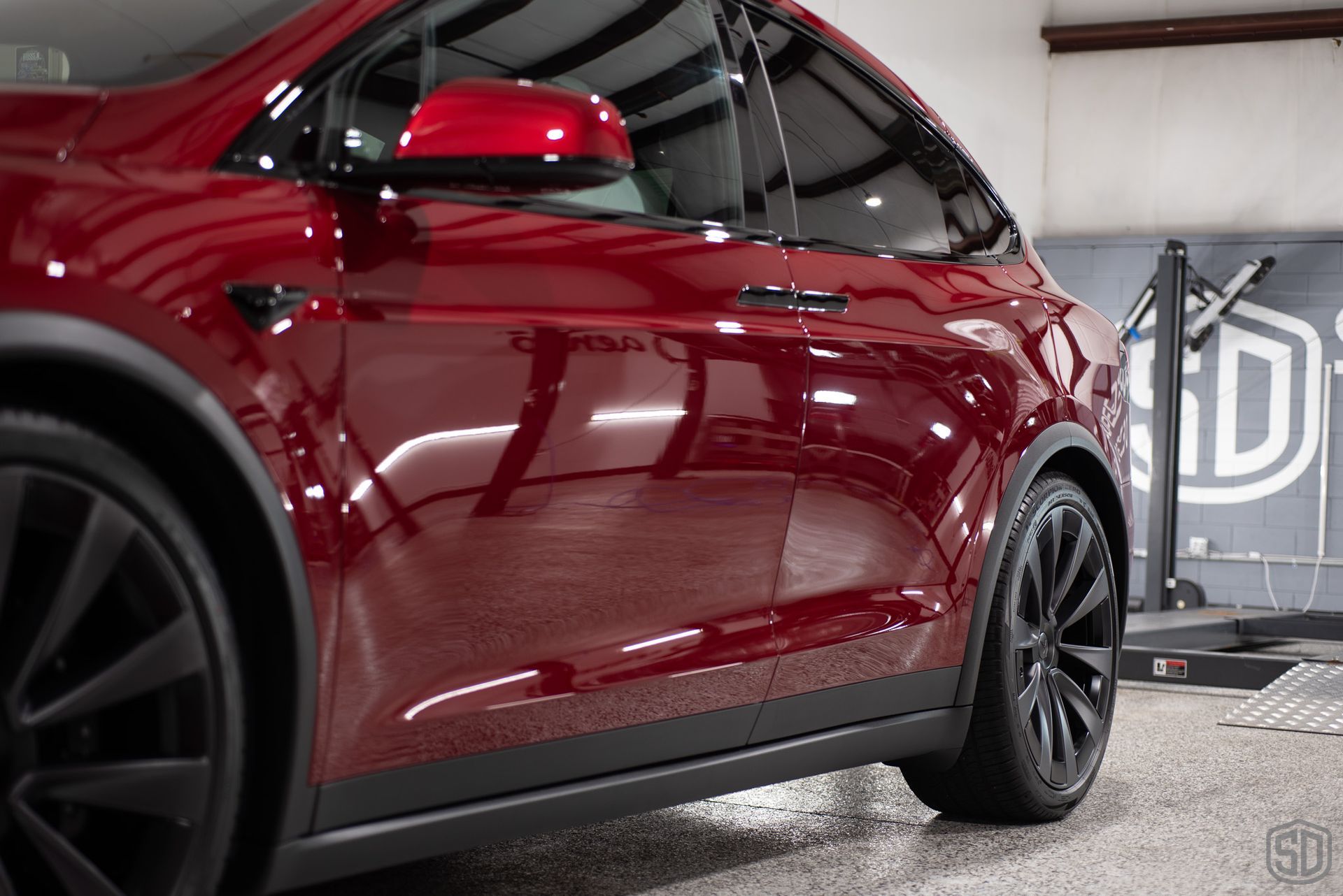 side view of red tesla