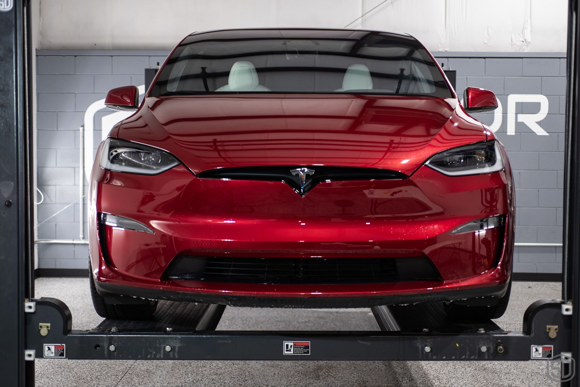 front of red tesla