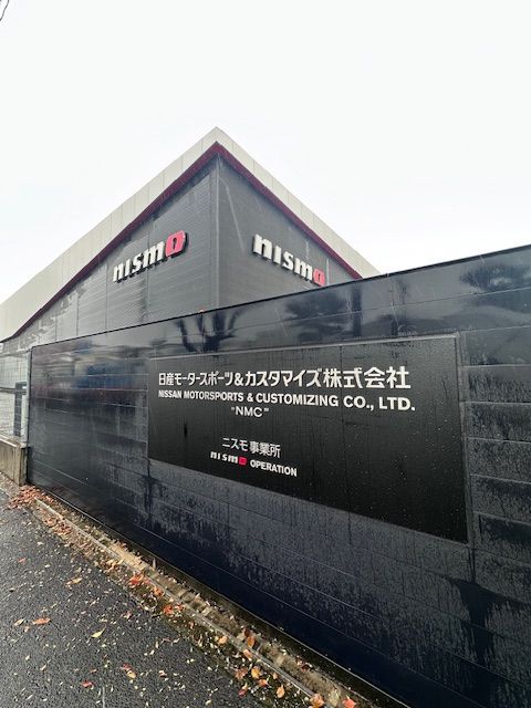 A building with a sign that says ' nismo ' on it