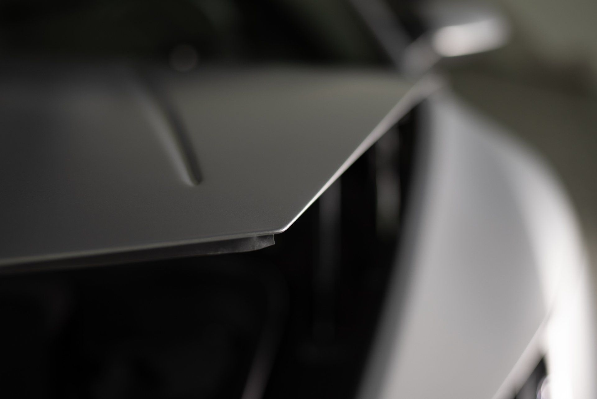 A close up of the hood of a silver car