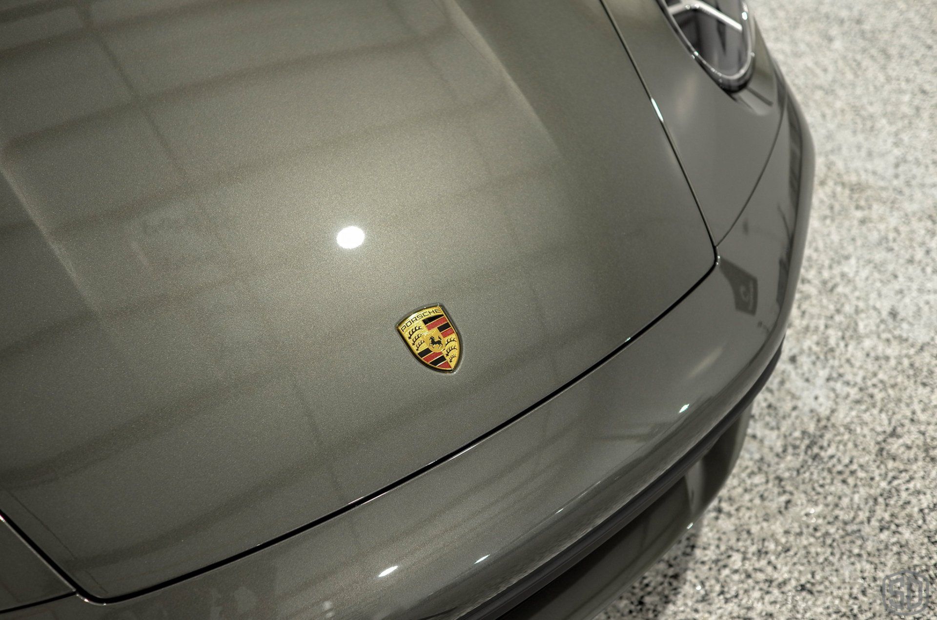 A close up of the hood of a porsche car