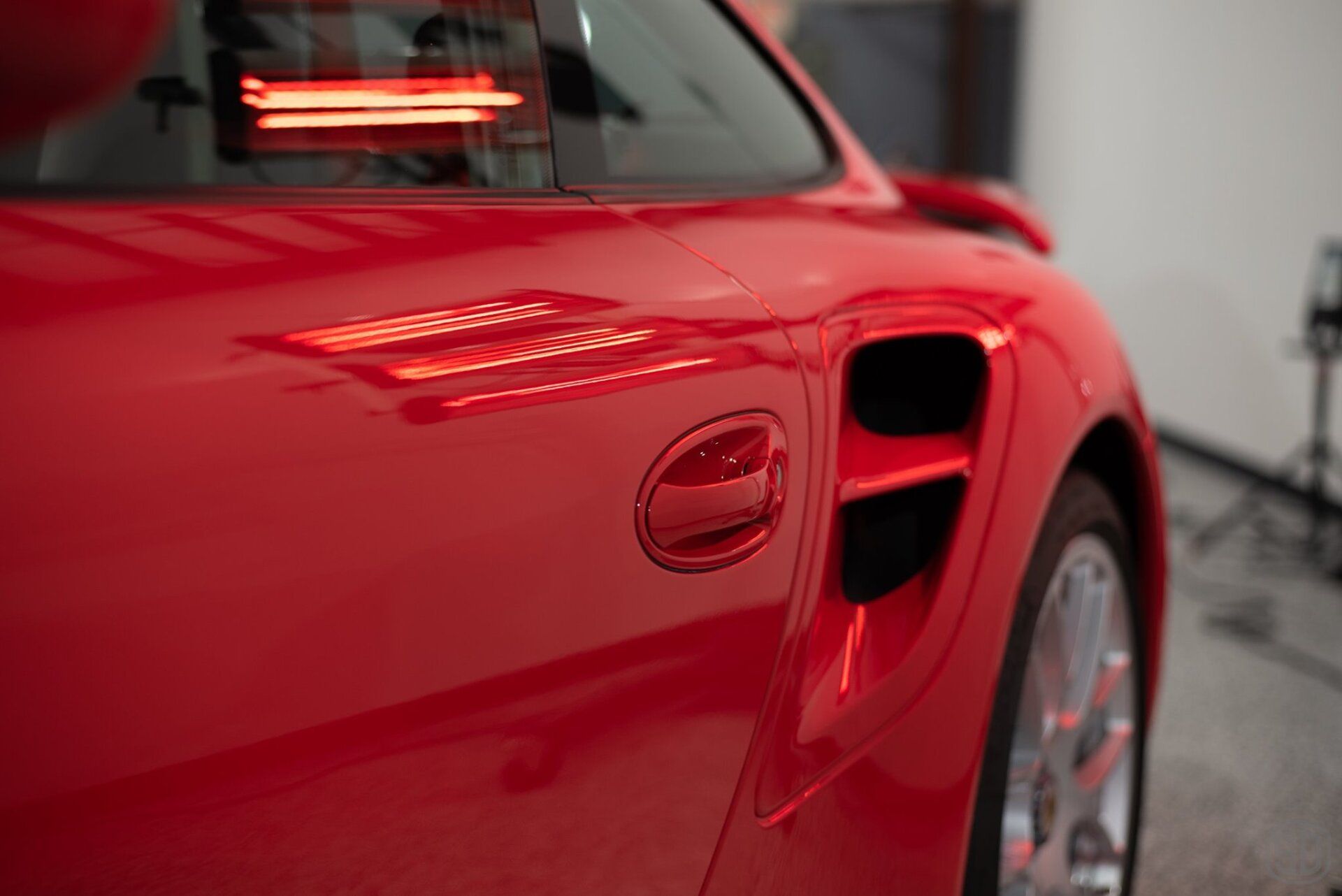 A close up of a red sports car in a garage.
