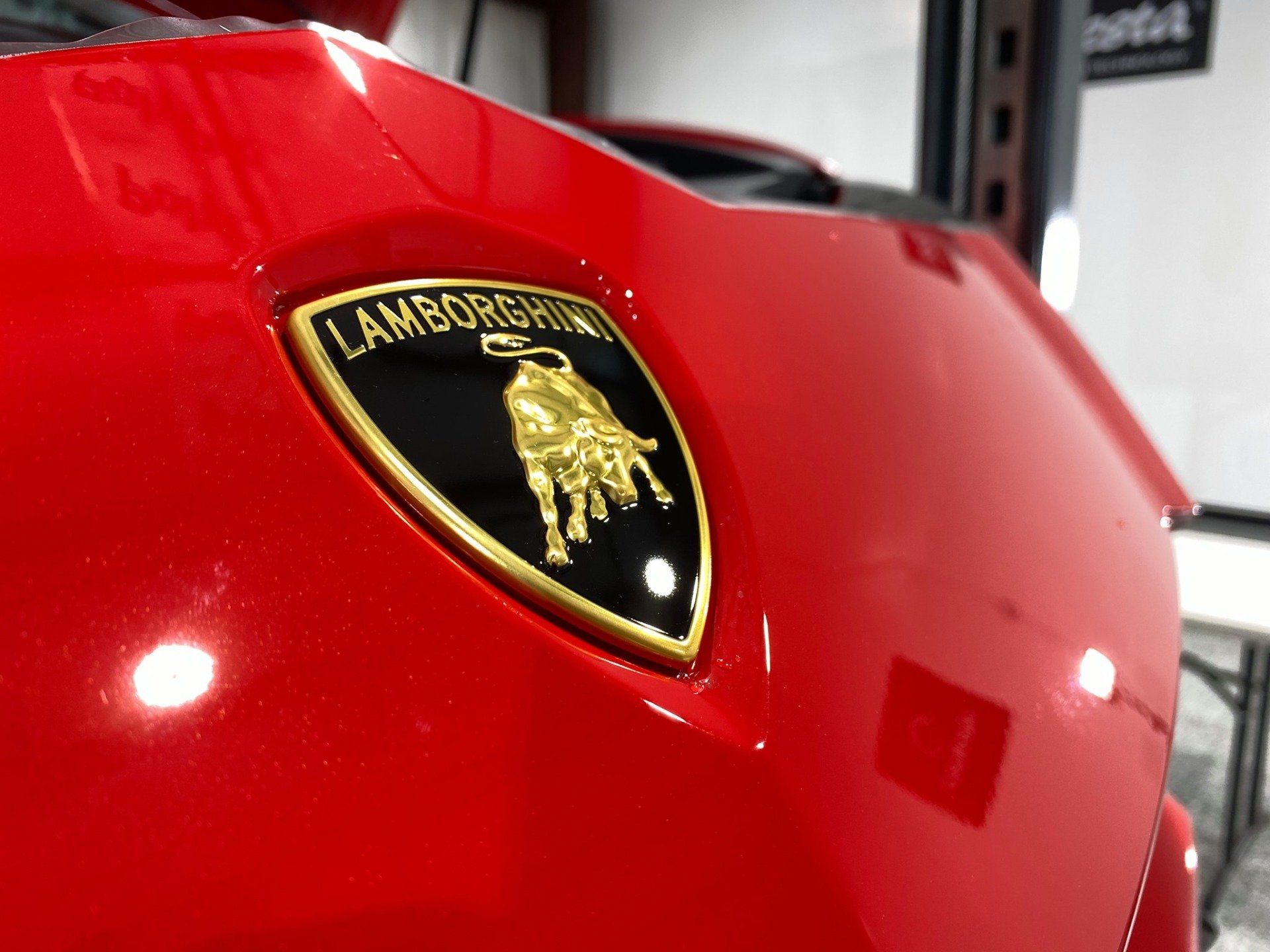 A red lamborghini car is parked in a garage