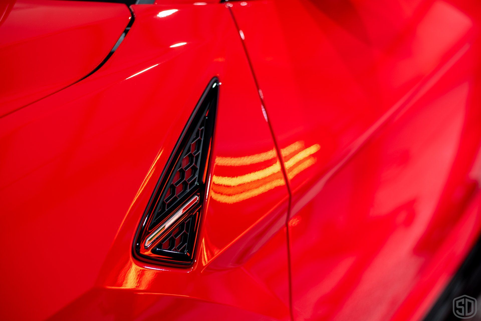 A close up of the side of a red car.