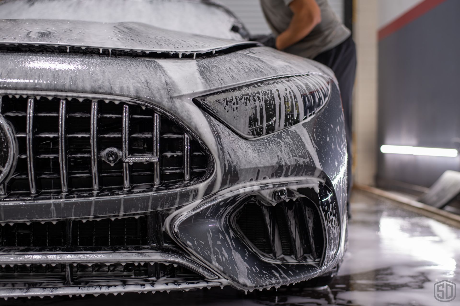 A man is washing a car.