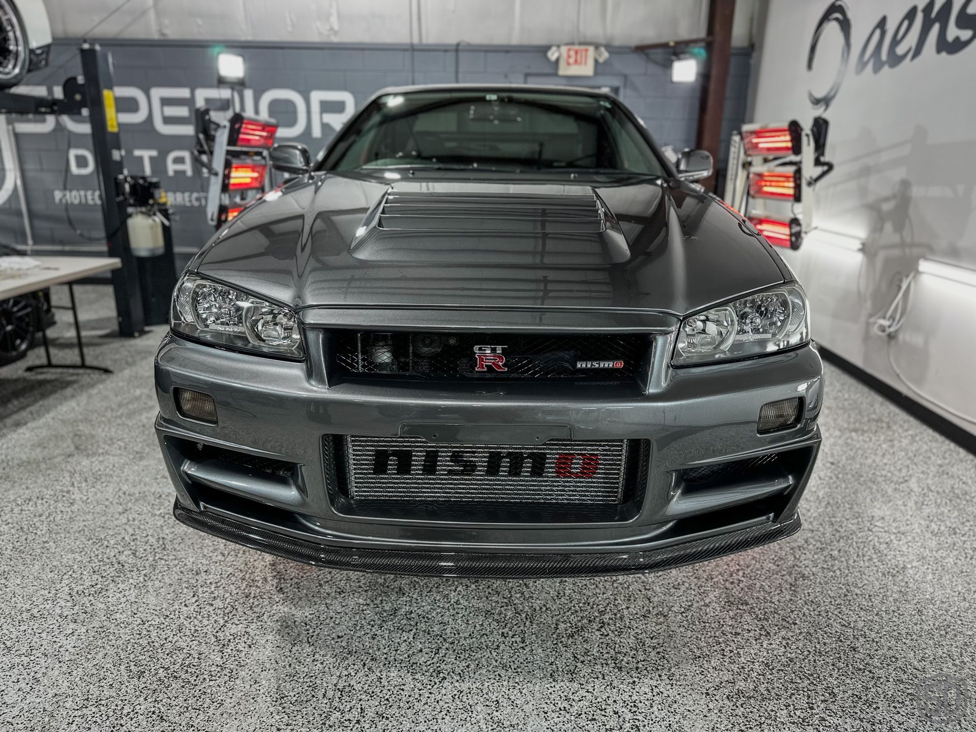 A nissan skyline r34 is parked in a garage.