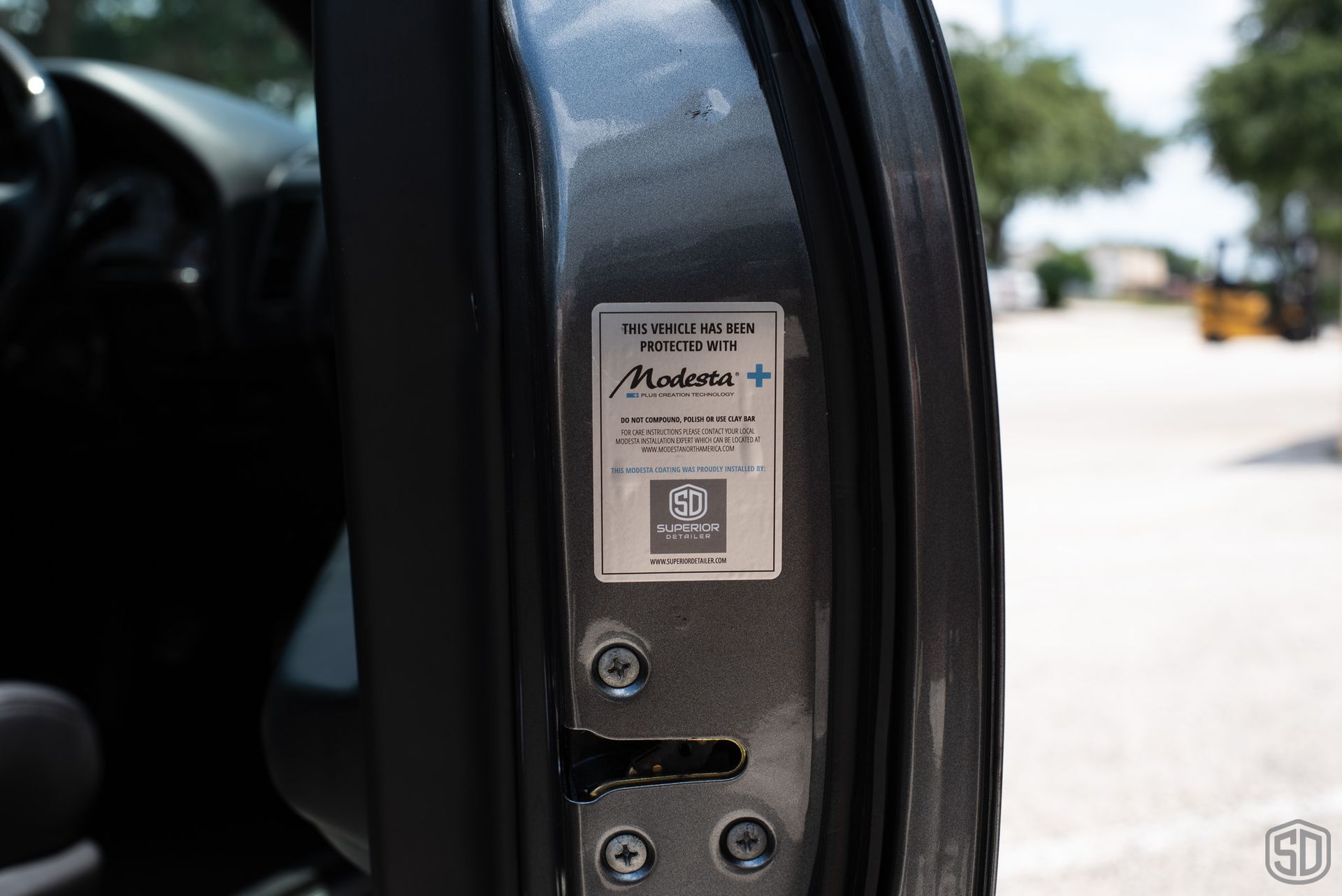 A close up of a car door with a label on it