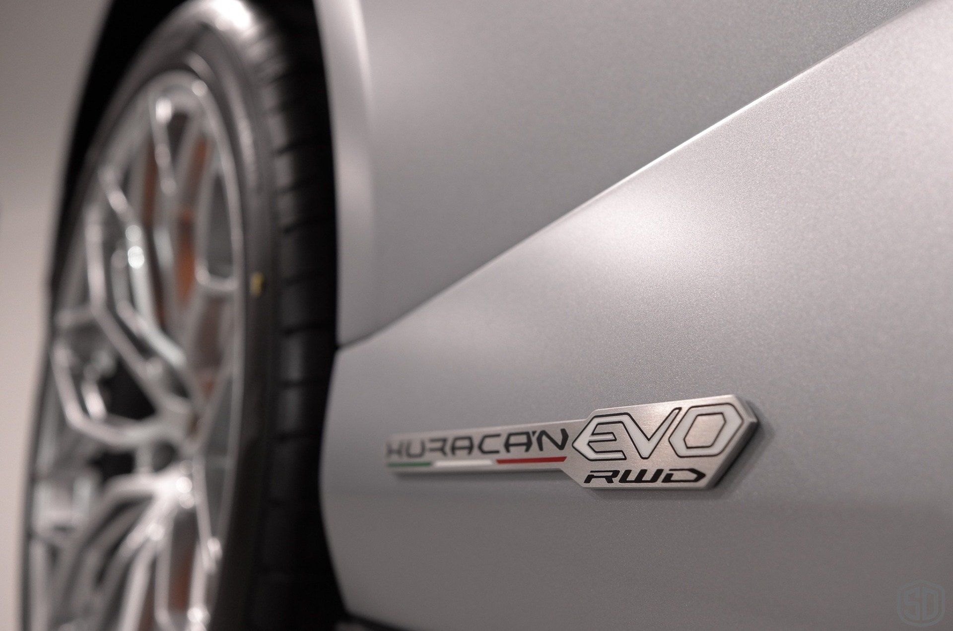 A close up of the side of a silver lamborghini evo
