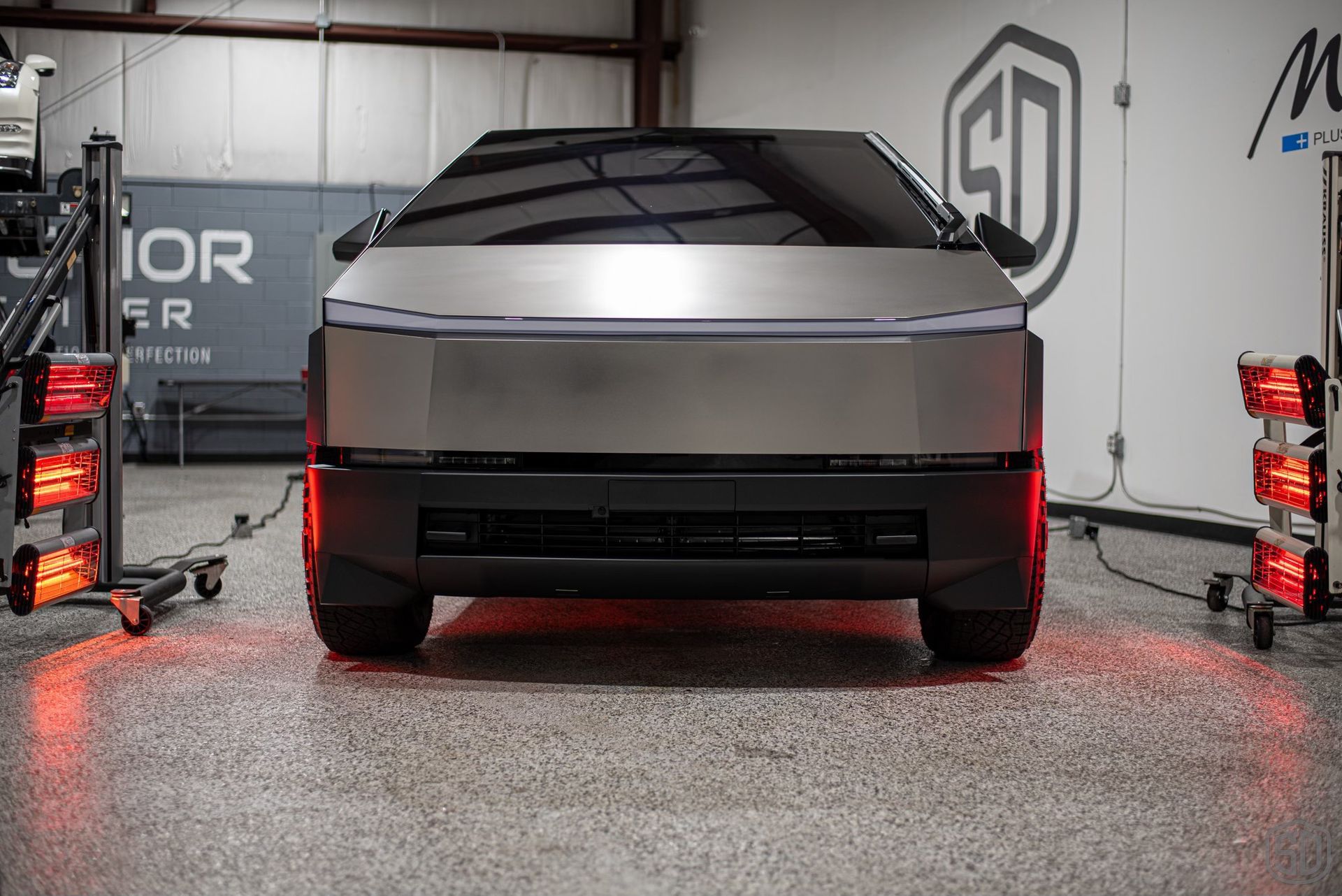 A tesla cybertruck is parked in a garage.