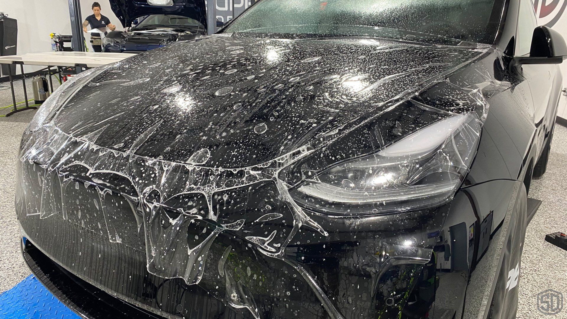 Tesla Model Y Signature Level 3 Heavy Paint Correction, Full Frontal PPF, modesta BC04 Nano Titanium Glass coating installation shot - Orlando Florida