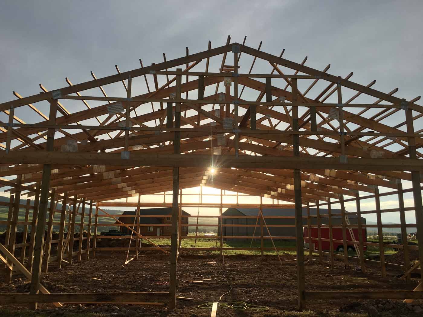 The sun is shining through the roof of a building under construction.
