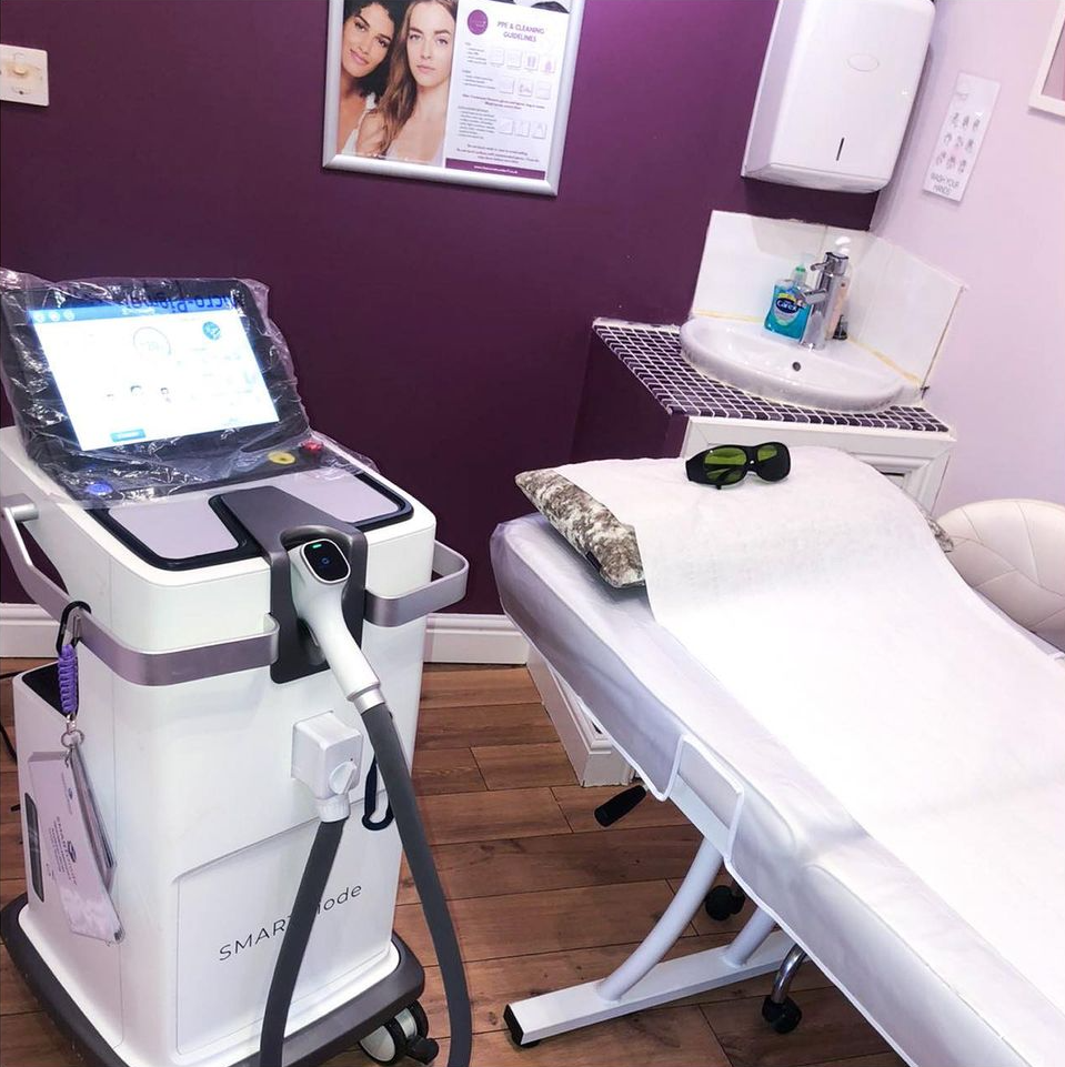 A purple room with a bed and a machine