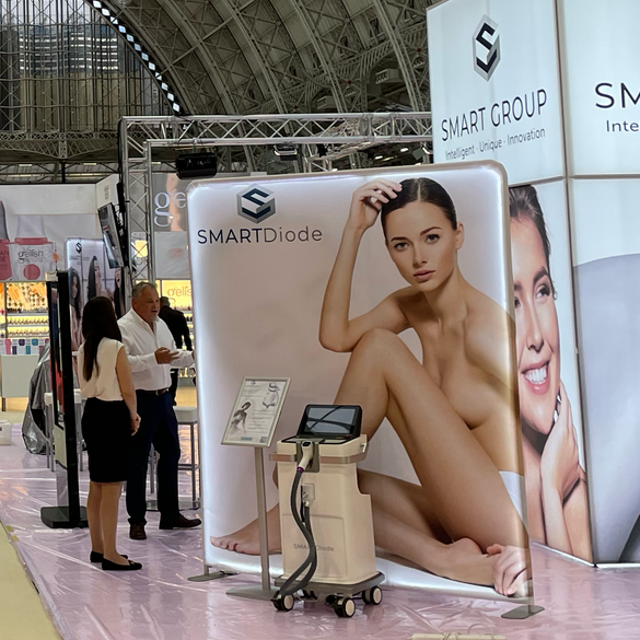 A woman is sitting in front of a sign that says smart diode