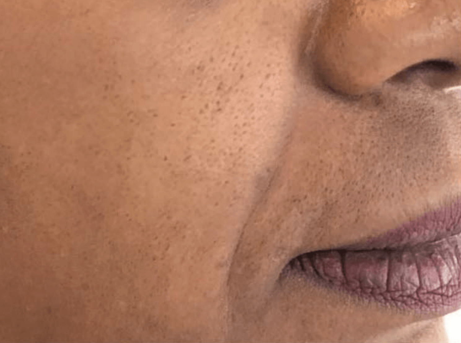 A close up of a woman 's face with her mouth open.