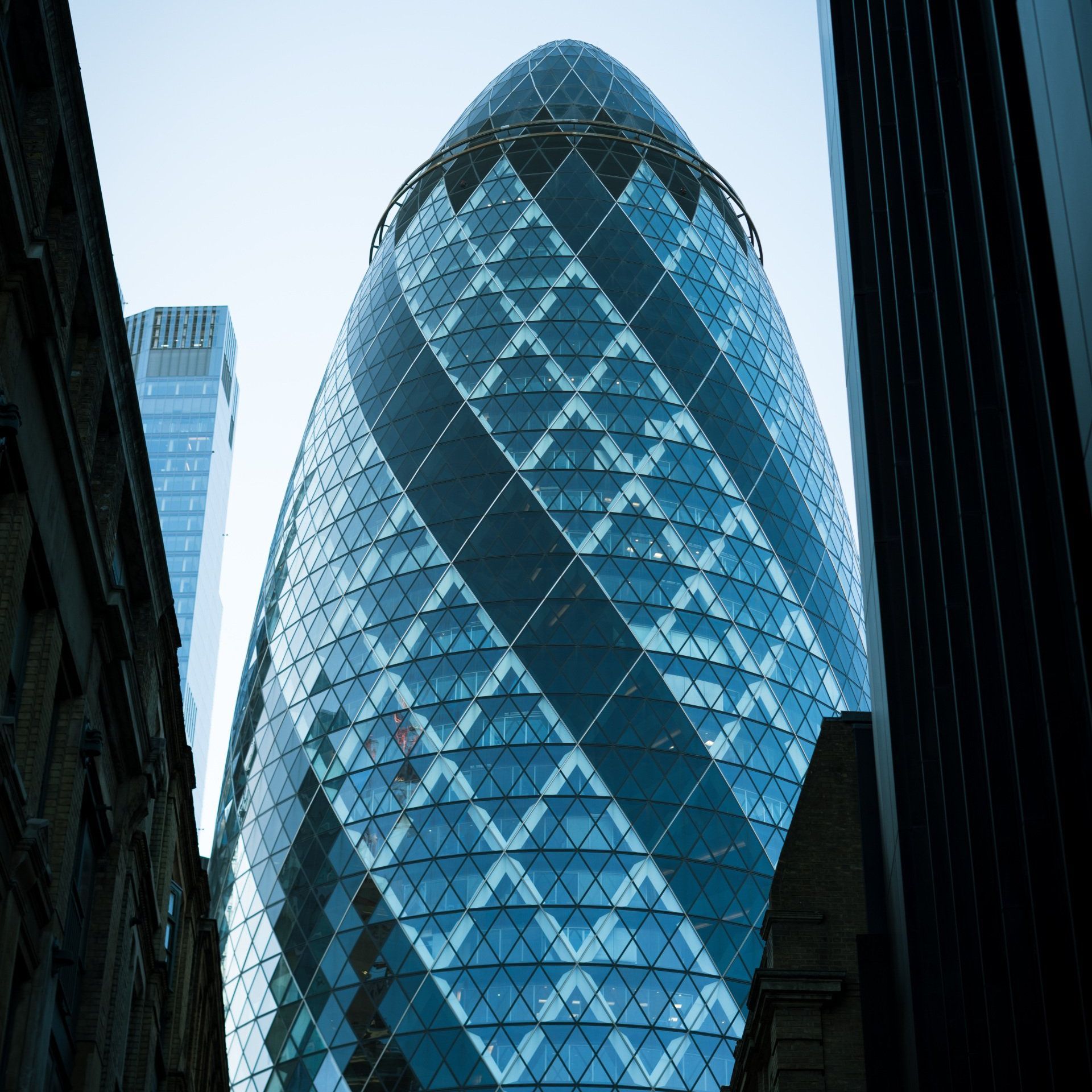 Looking up at a very tall building that looks like an egg