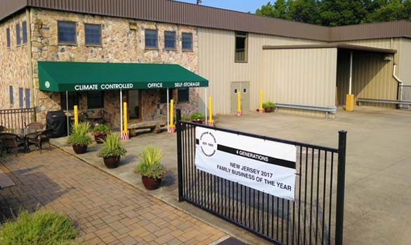 Exterior view of Climate Control Corporation building. Stone facade, green awning, sign: NJ Small Business of the Year.