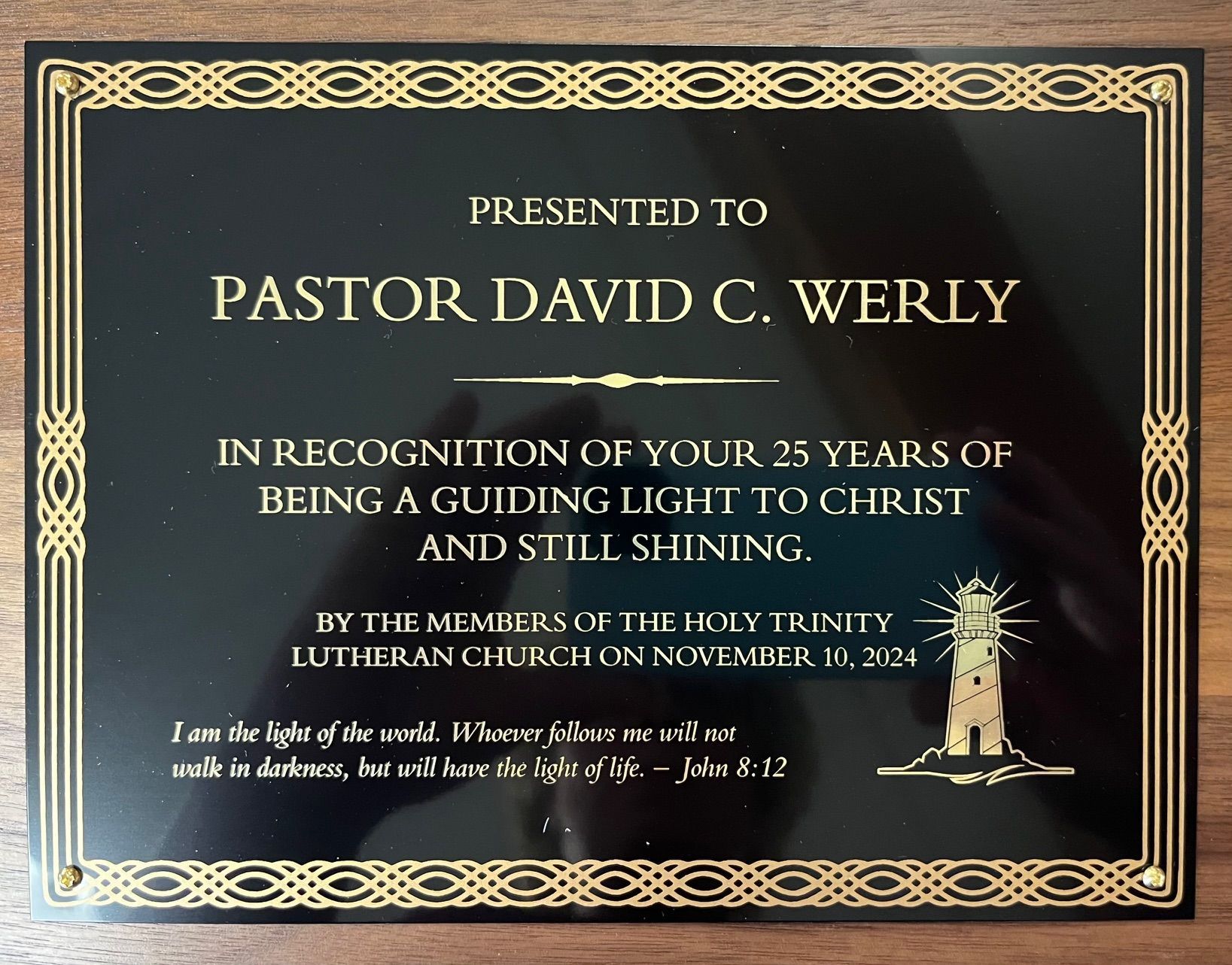 A black and gold plaque presented to pastor david c. werly