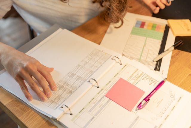 person reviewing a folder with documents