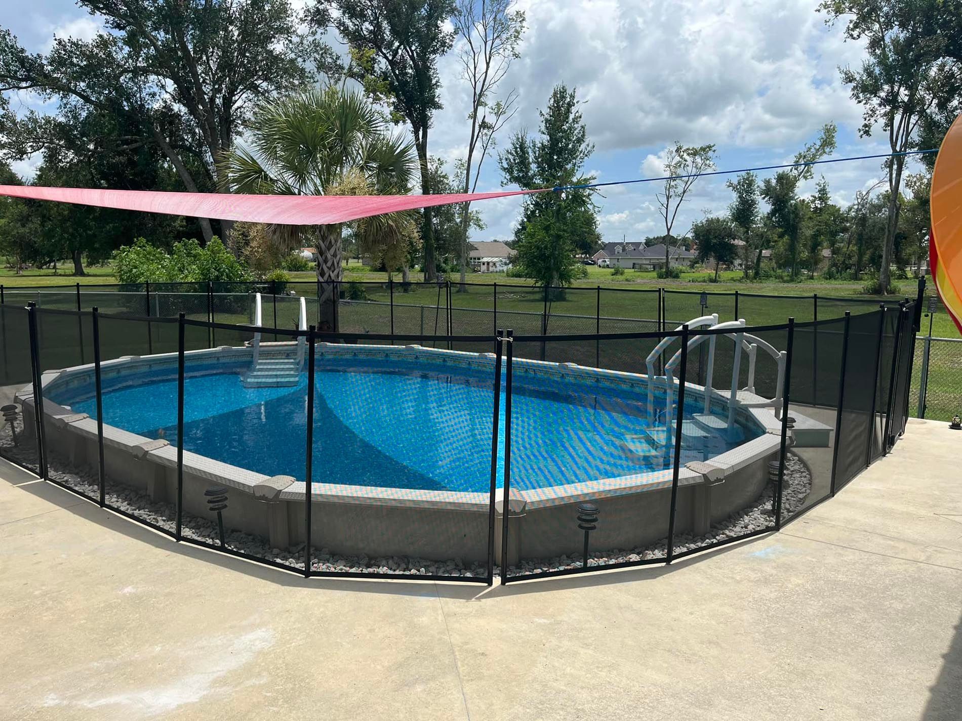 A large swimming pool with a fence around it