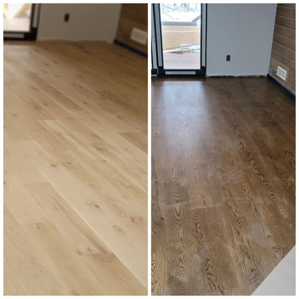 Two hardwood floors: one light, one dark, in a room with a door to a deck.