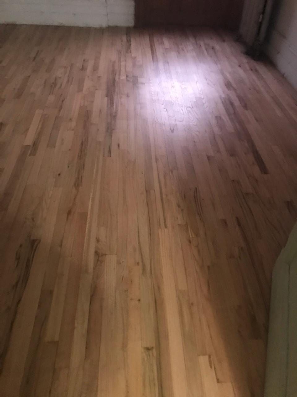 Light wooden hardwood floor with variations in color and grain.