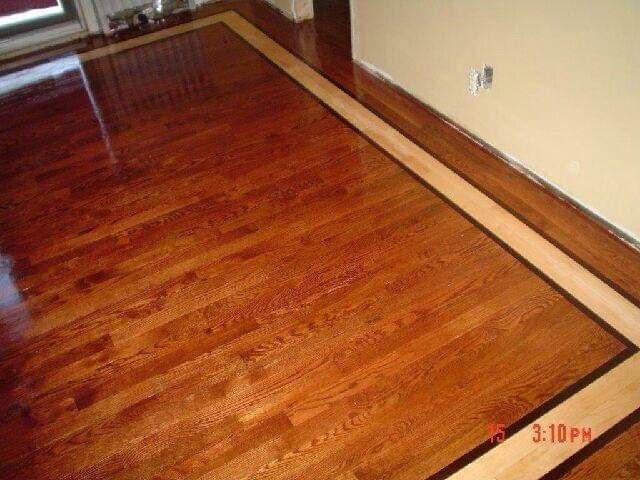 Wooden floor with a darker central area and a light wood border.