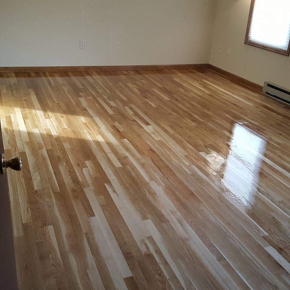Hardwood floor in an empty room, with light streaming through a window.