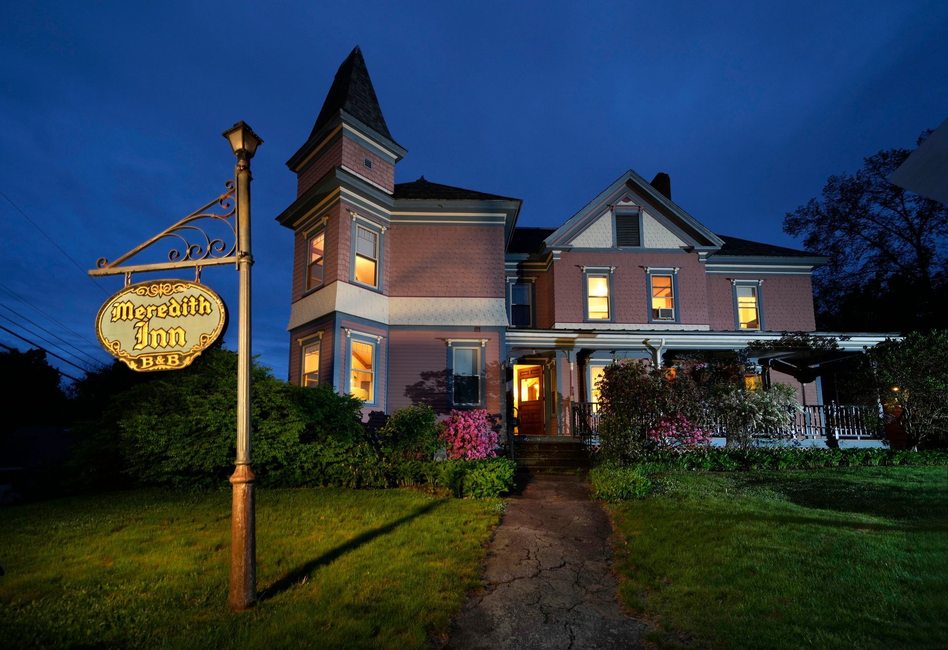 Front image of pink historic Victorian home