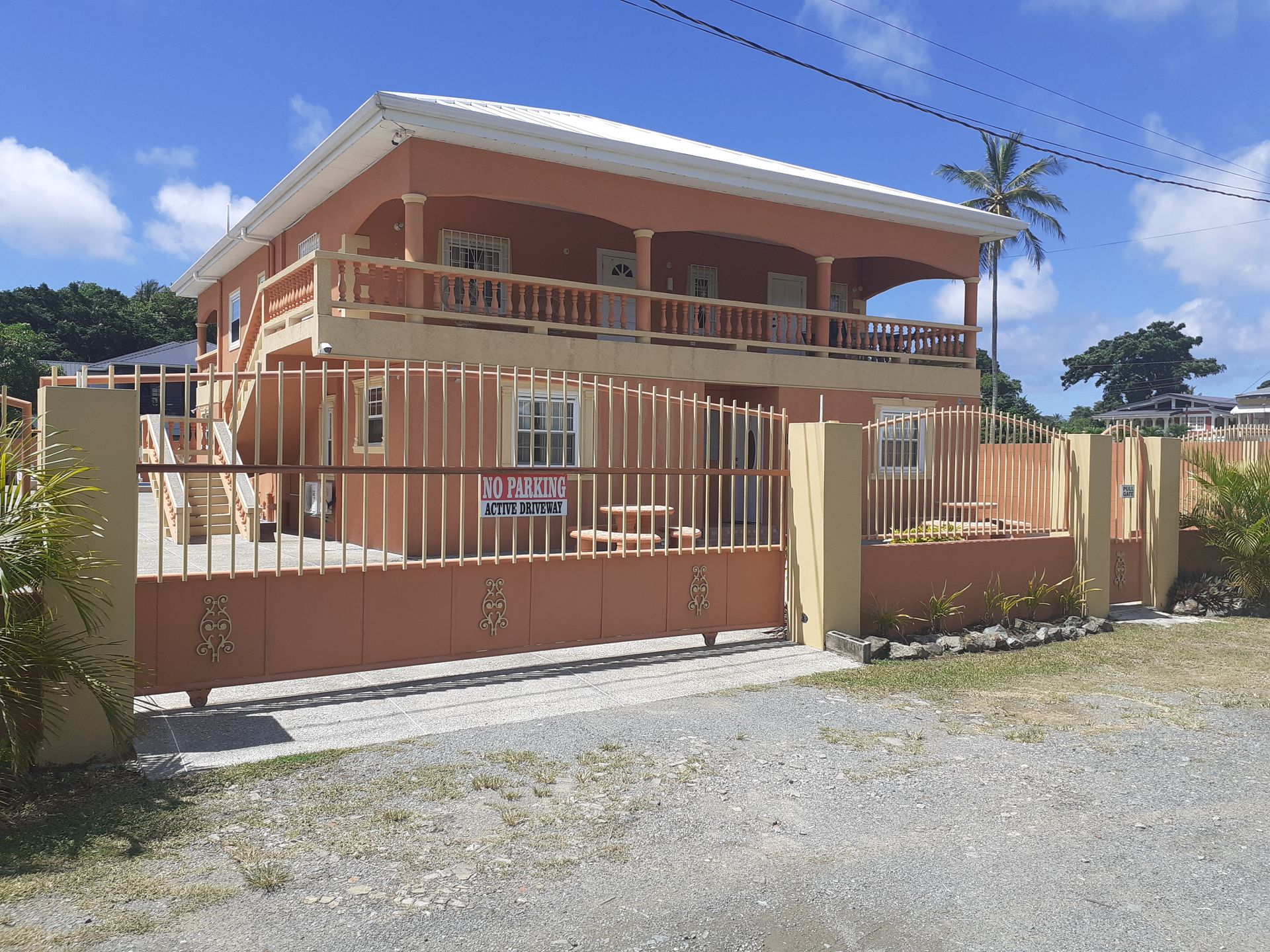 A large house with a fence around it is for sale.