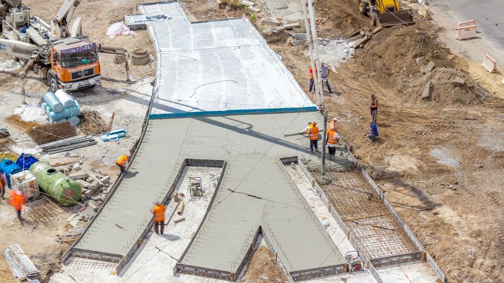 An aerial view of a construction site with workers and a truck.