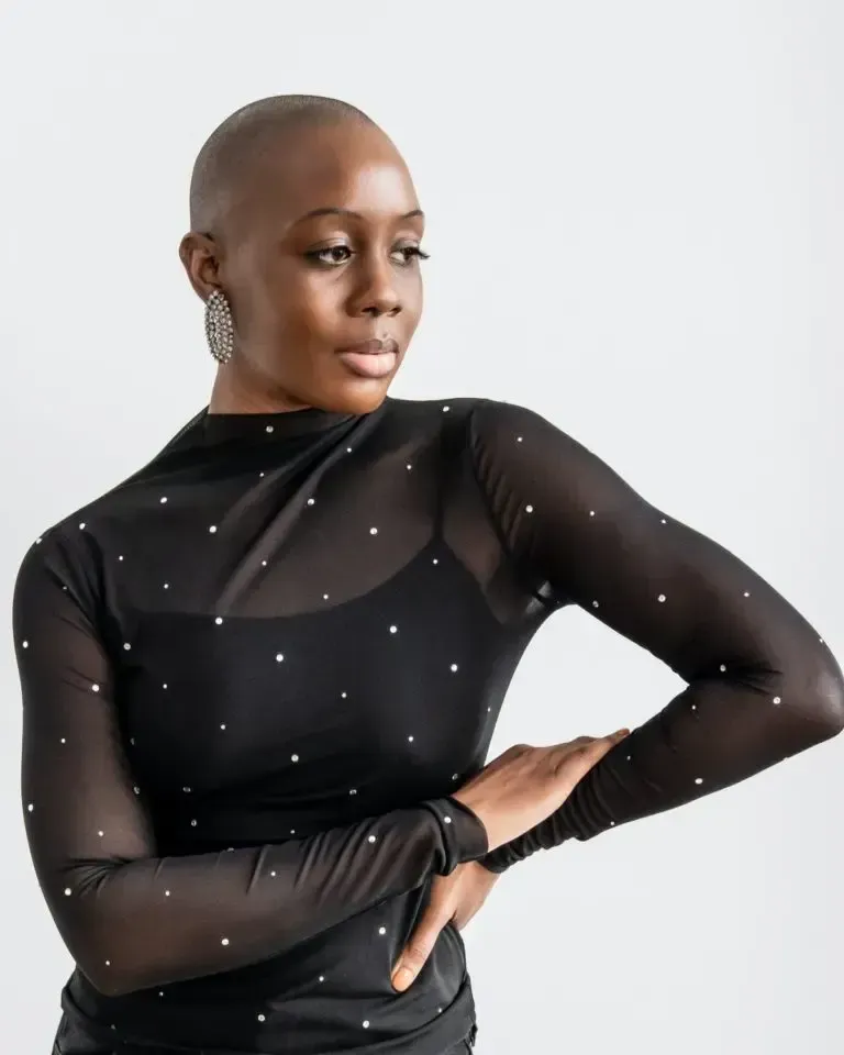 A woman wearing a black top with white dots on it