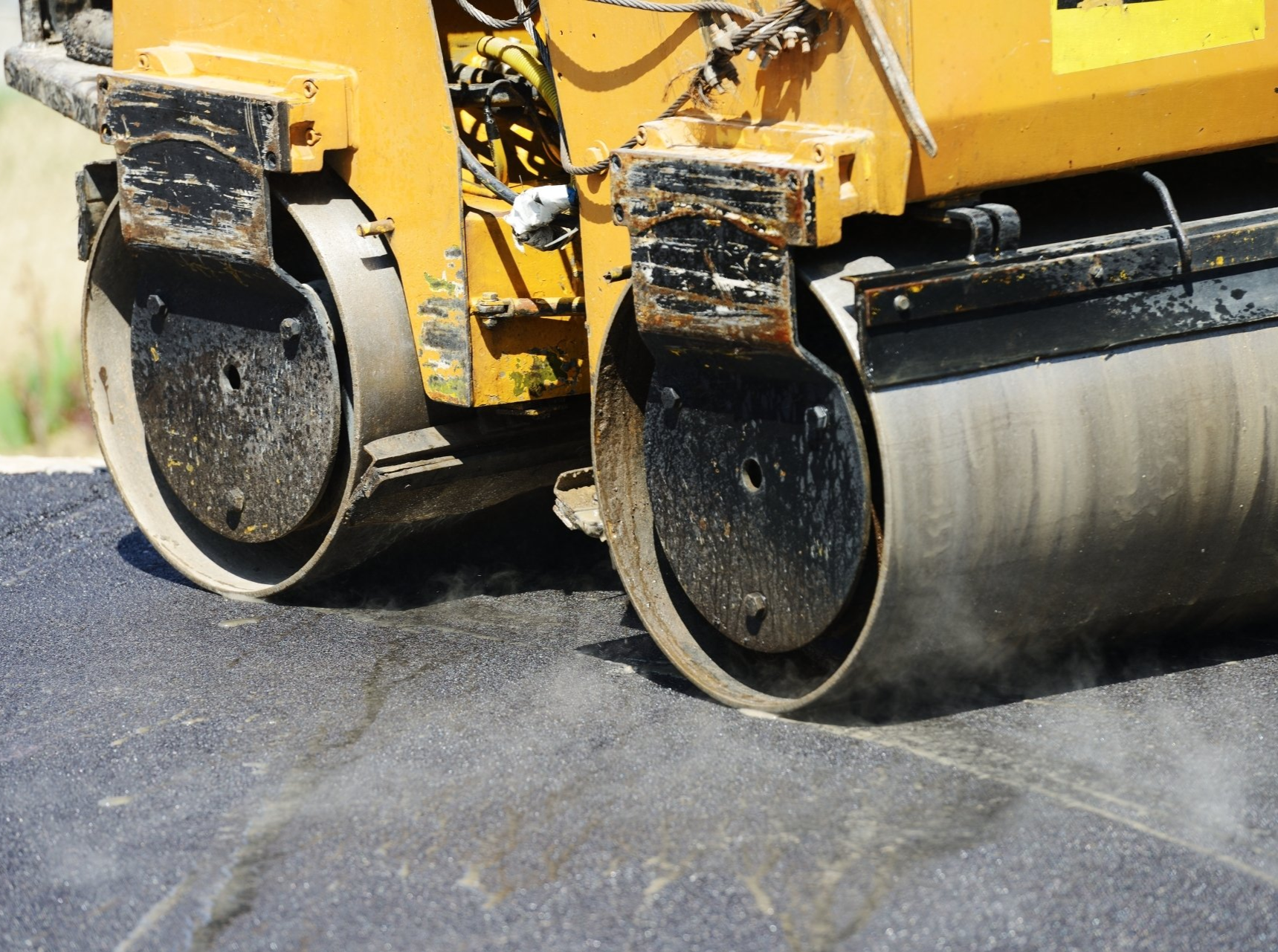 Small asphalt roller compacting an asphalt resurface in El Paso, TX