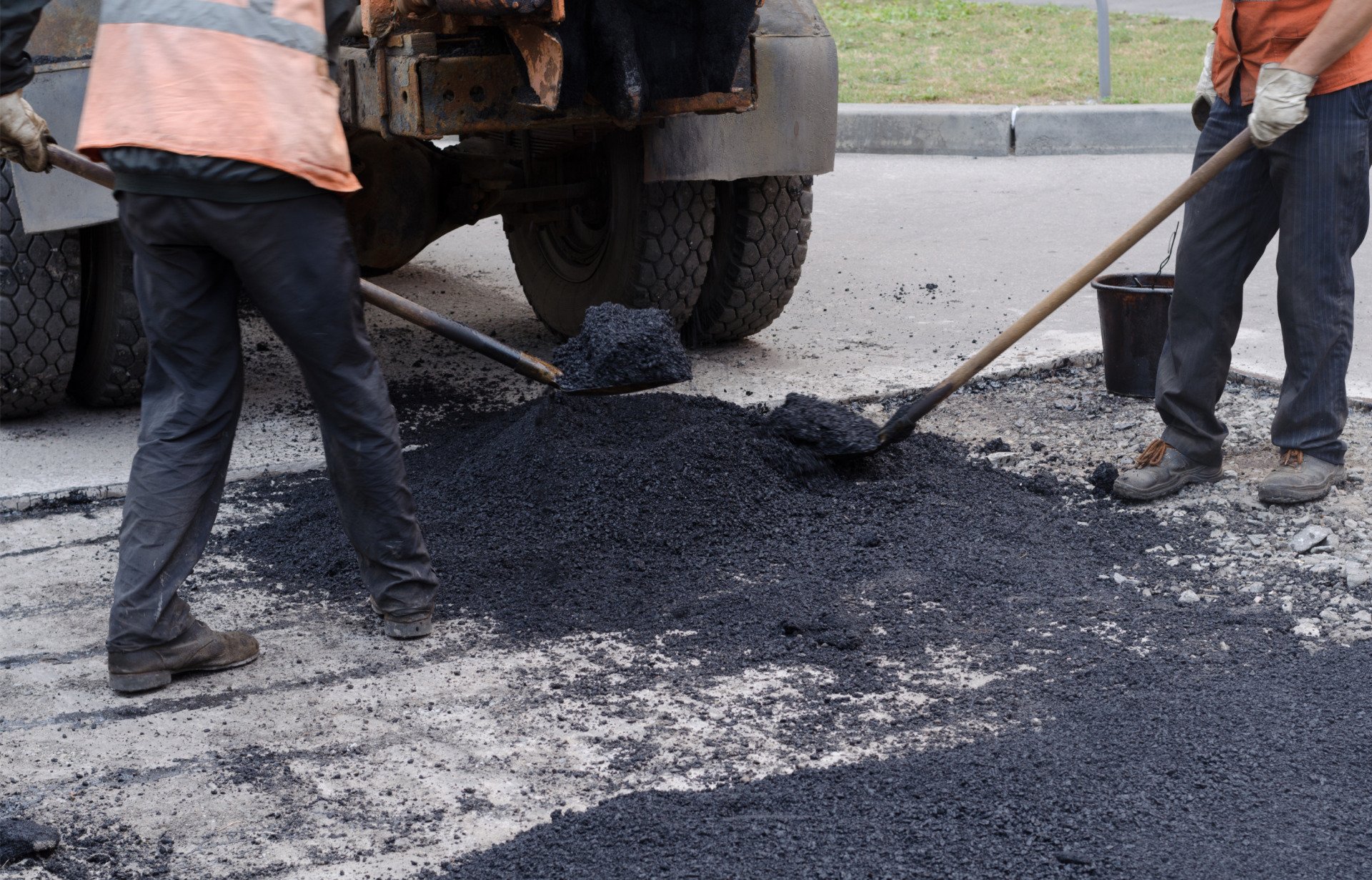 To prevent further damage and reduce long-term repair costs, the parking lot repair contractors are filling the pothole.