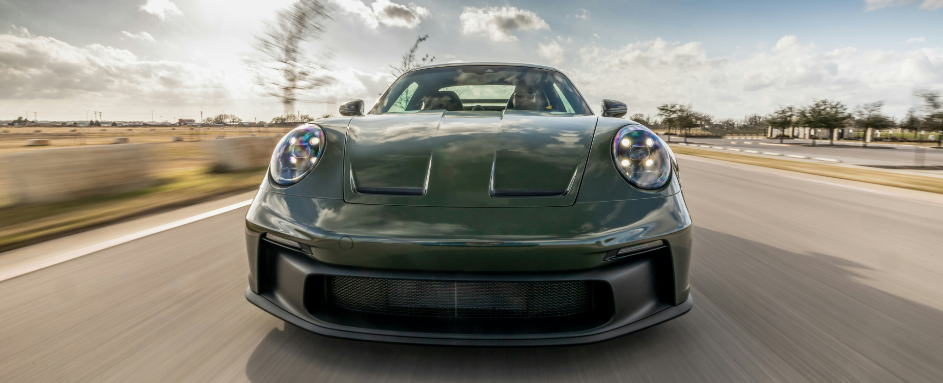 Group of auto mechanics in uniform posing together in a shop.