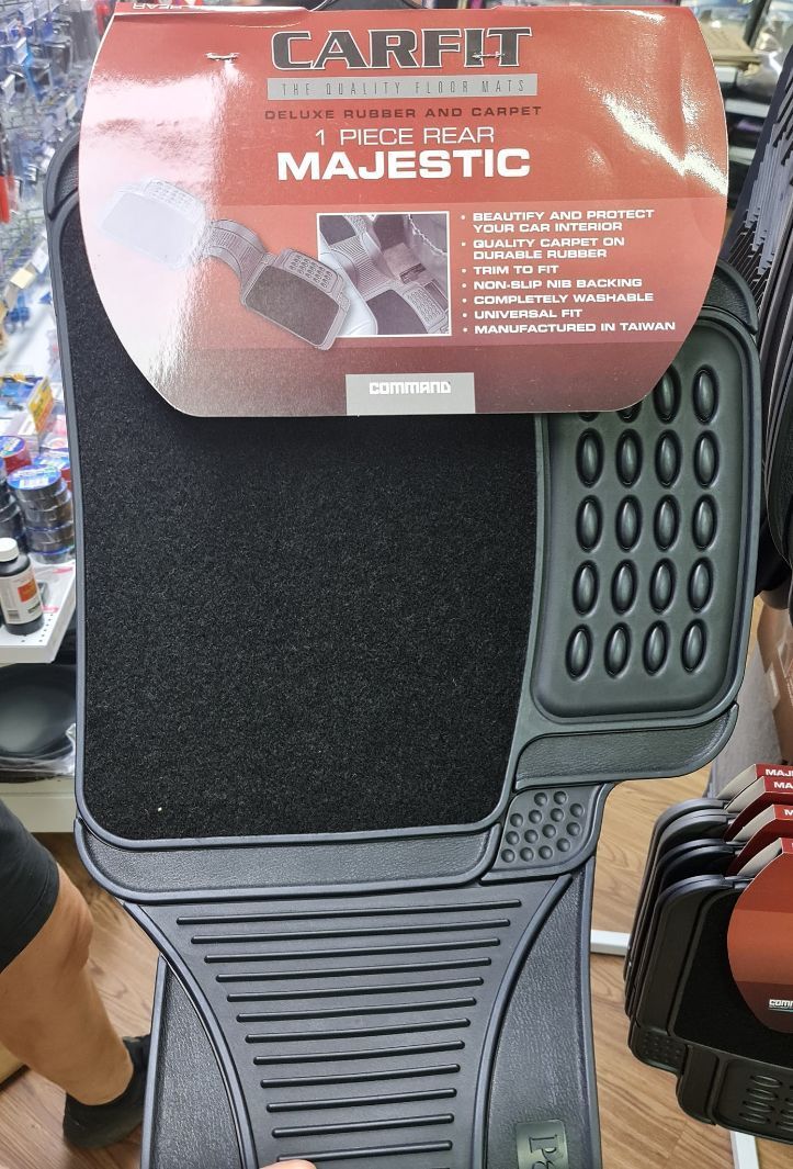 A Black Car Mat Is Sitting On Top Of A Wooden Table — Camden Haven Auto Parts In Laurieton, NSW