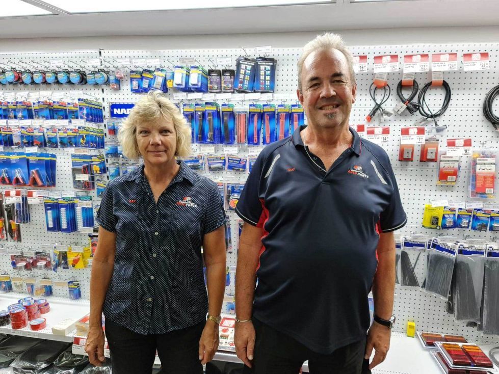 A Man And A Woman Are Standing Next To Each Other In A Store — Camden Haven Auto Parts In Laurieton, NSW