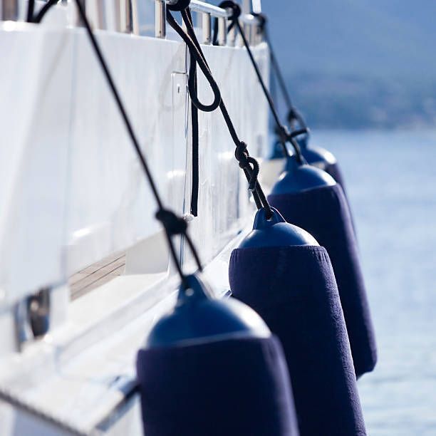 Modern yacht fenders attached with ropes