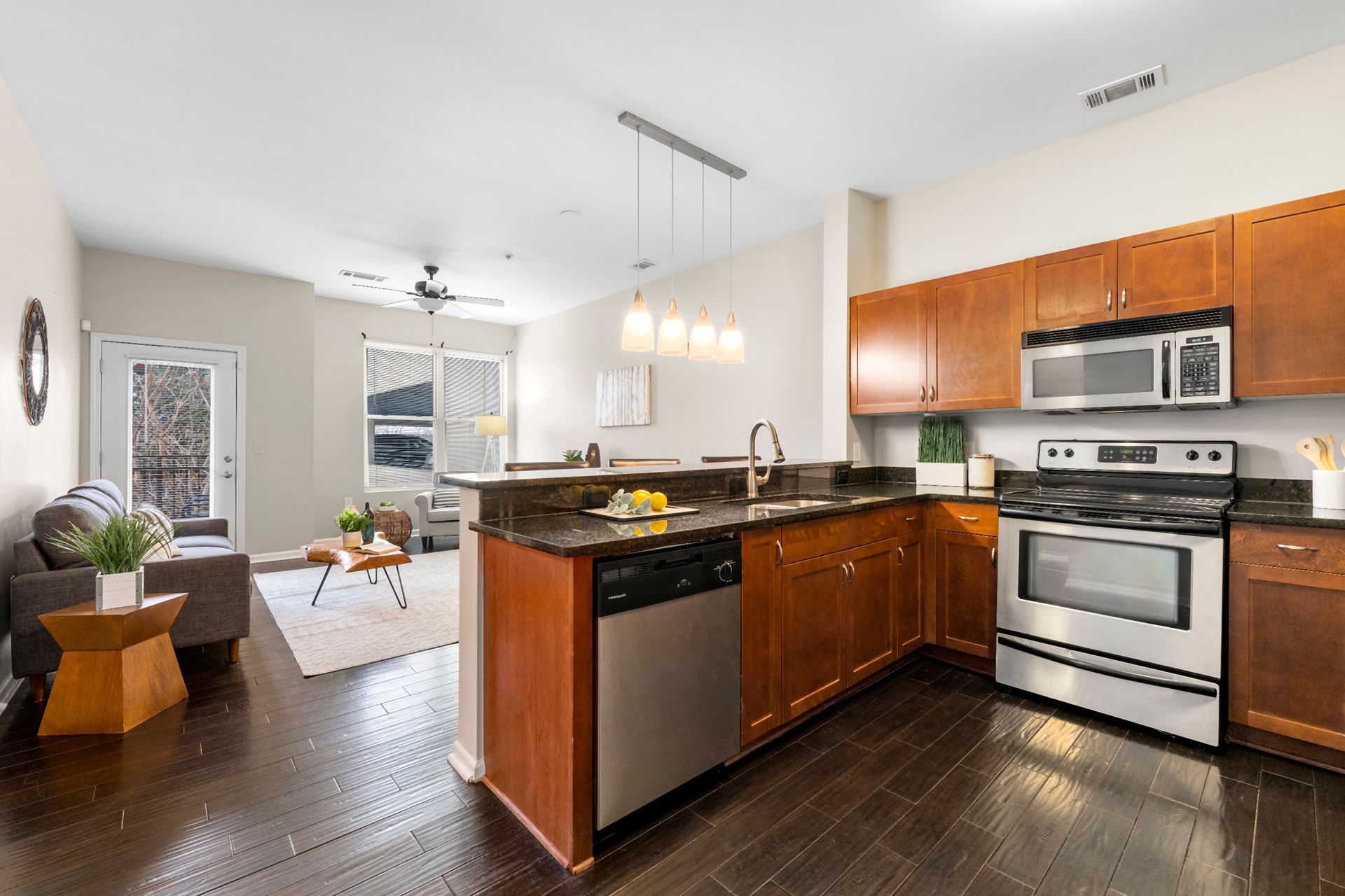 A kitchen with wooden cabinets , stainless steel appliances , and a stove.