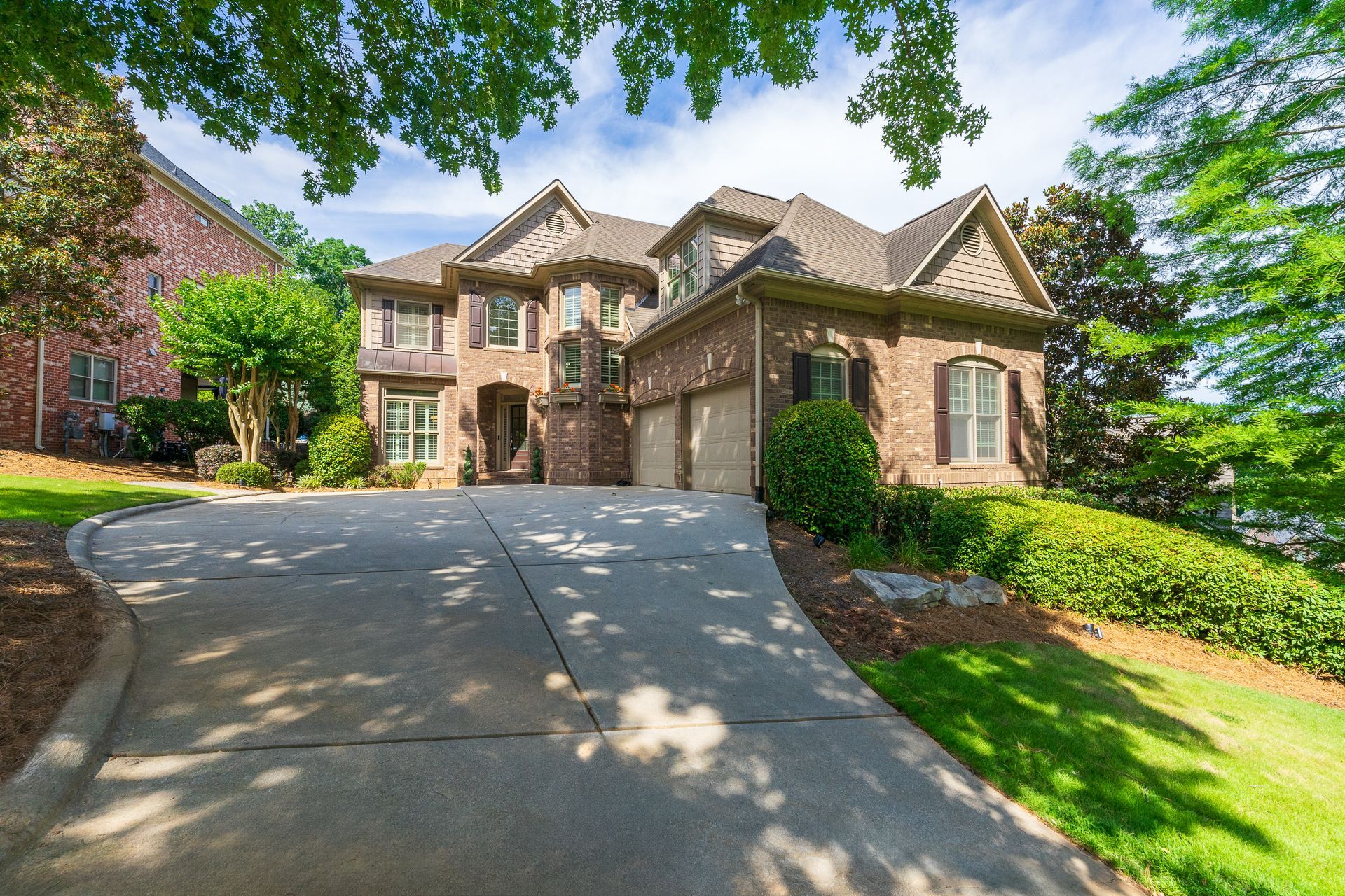 A stunning Queen Anne-style home in Vinings Estates with a brick façade and distinctive Rapunzel tower. 