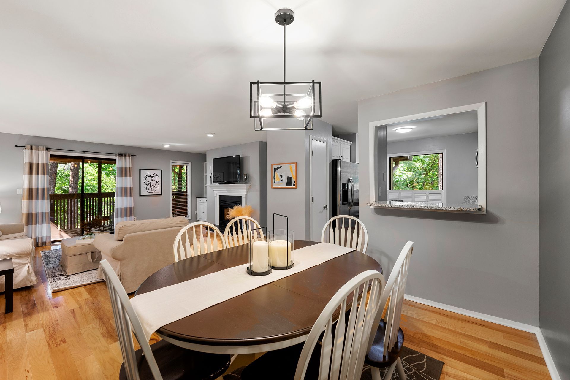 A dining room table with candles on it in a living room.