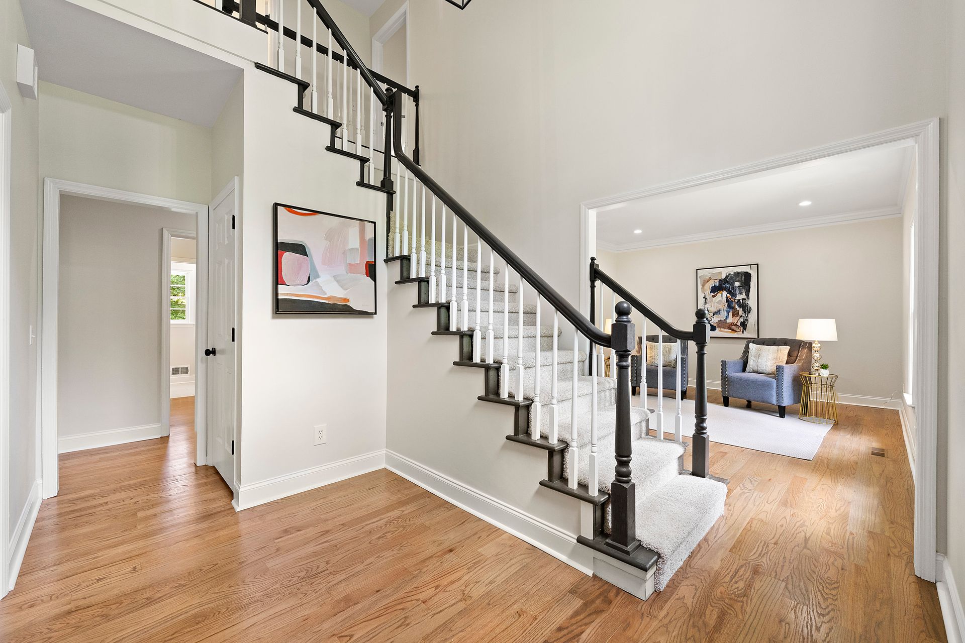 There is a staircase in the middle of the hallway leading up to the second floor.