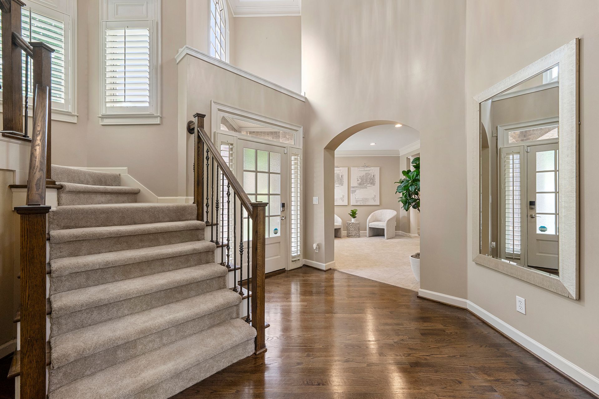A hallway with stairs leading up to the second floor of a house.