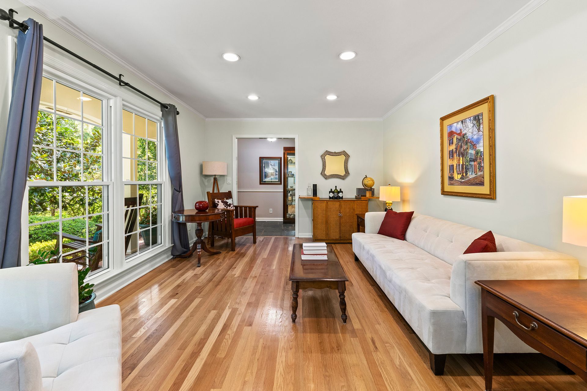 A living room with hardwood floors and a white couch