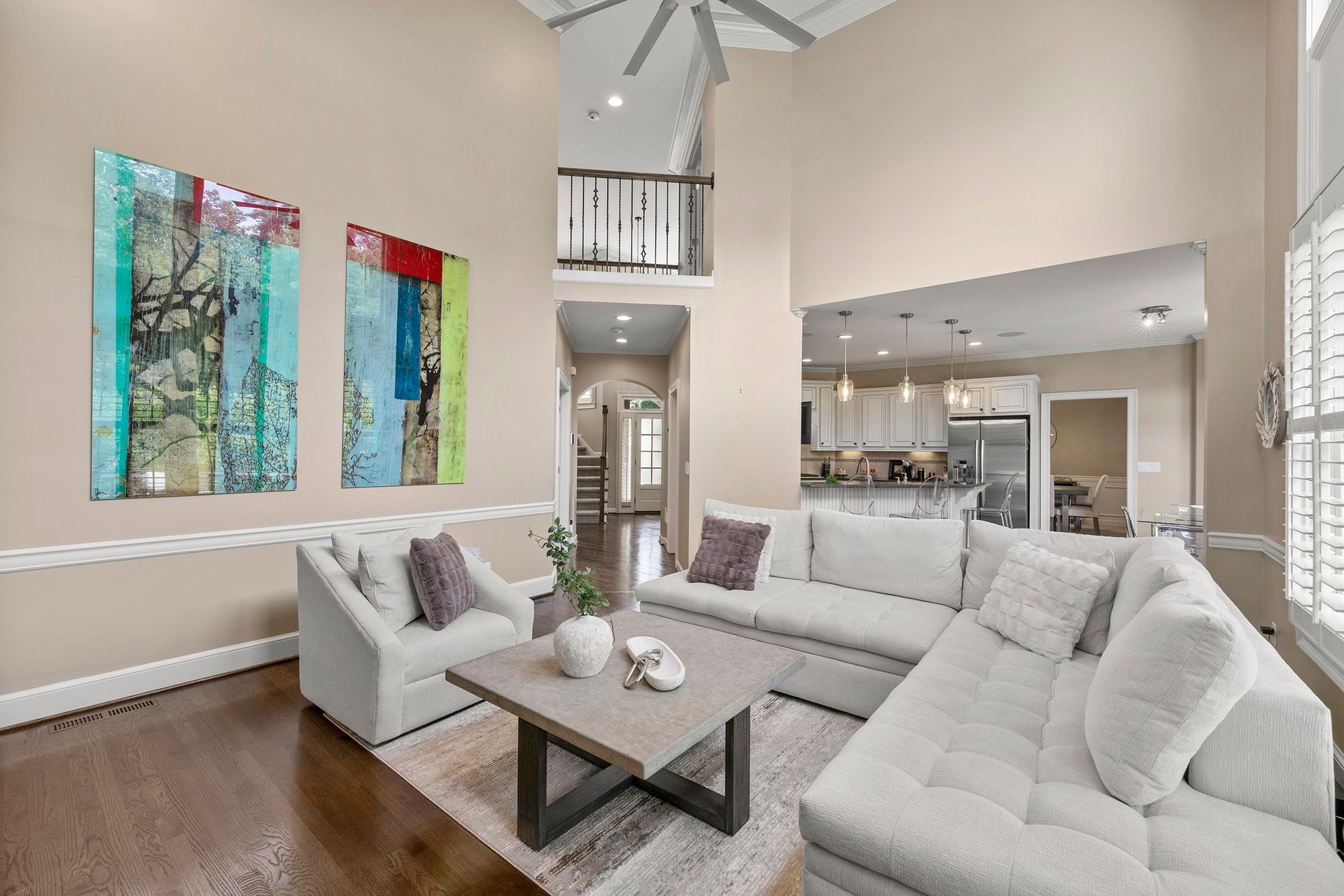 A living room filled with furniture and a ceiling fan.