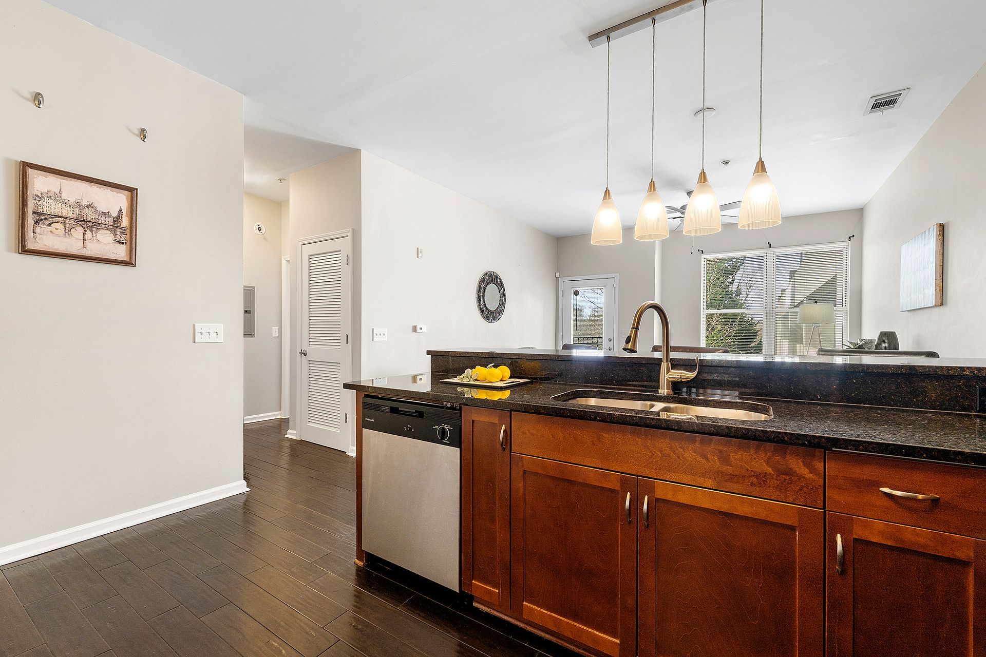 A kitchen with stainless steel appliances and wooden cabinets
