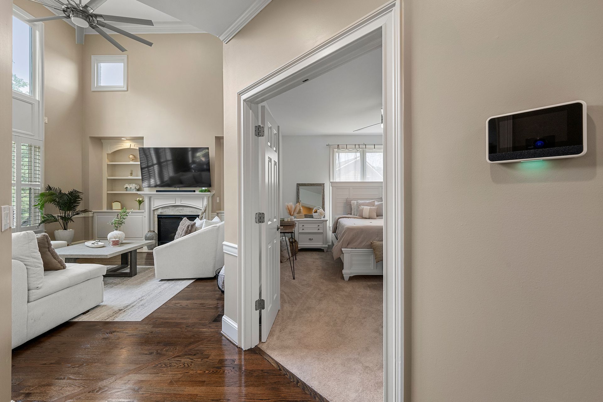 A living room with a couch , chair , television and fireplace.