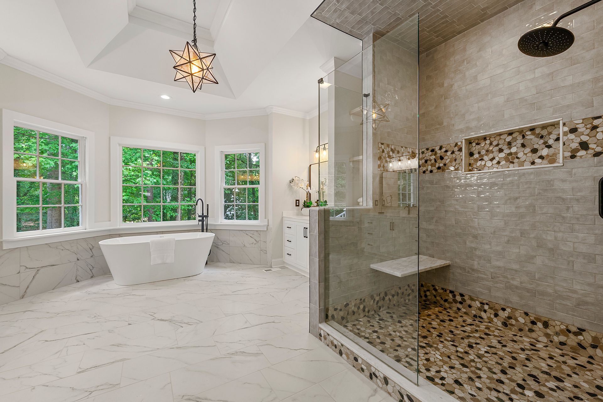 A bathroom with a tub and a walk in shower.