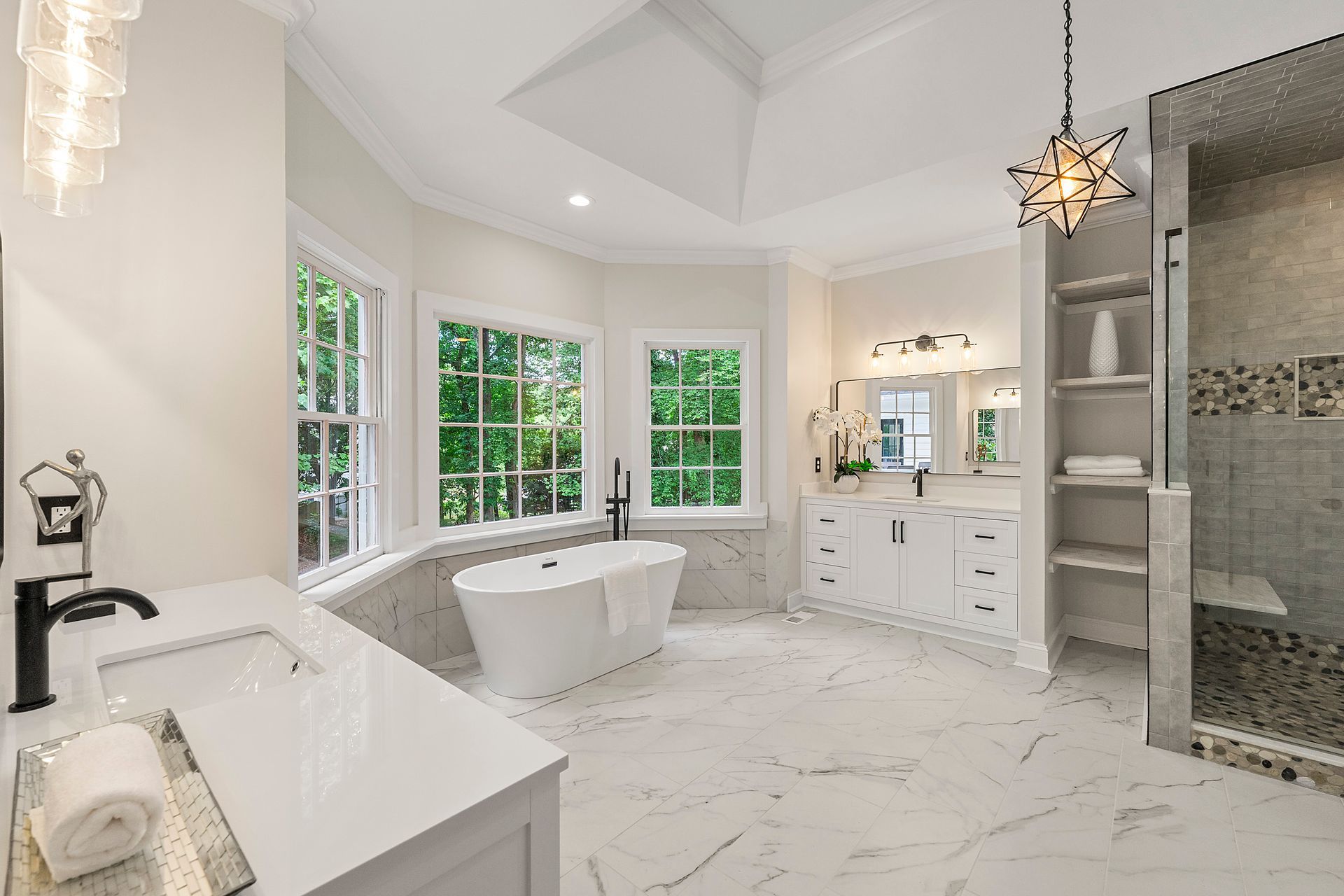 A bathroom with a tub , sink , mirror and shower.